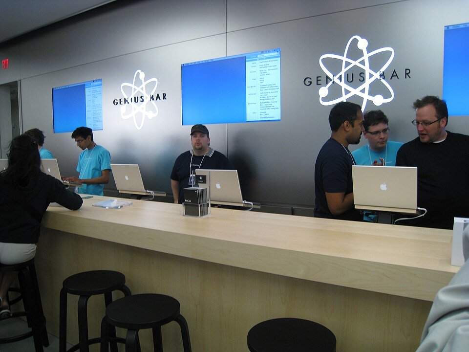 Apple Genius Bar counter with staff helping several customers