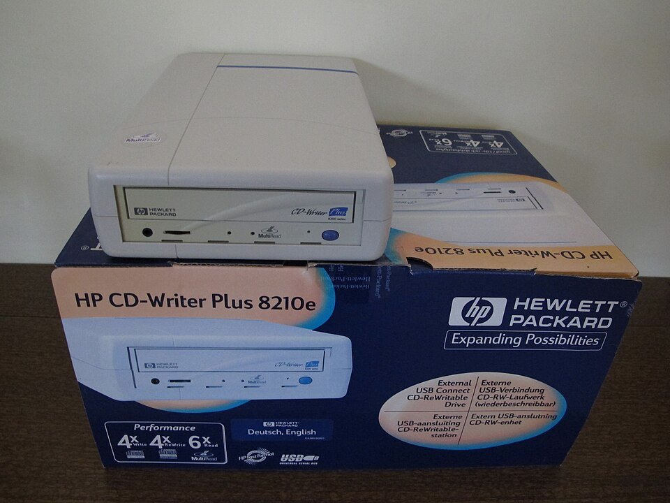 External HP CD-RW writer beside its USB-connect retail box