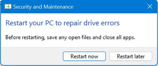 Security and Maintenance notification prompting a restart to repair drive errors
