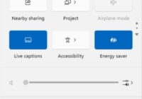 Windows 11 Quick Settings panel showing Live captions, Energy saver and a page-scroll arrow
