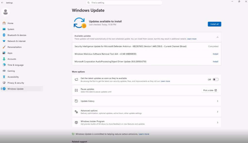 Windows Update page listing available updates with a Pick a date button for pausing