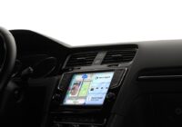 Apple CarPlay Dashboard on a car's dashboard touchscreen showing Maps and music