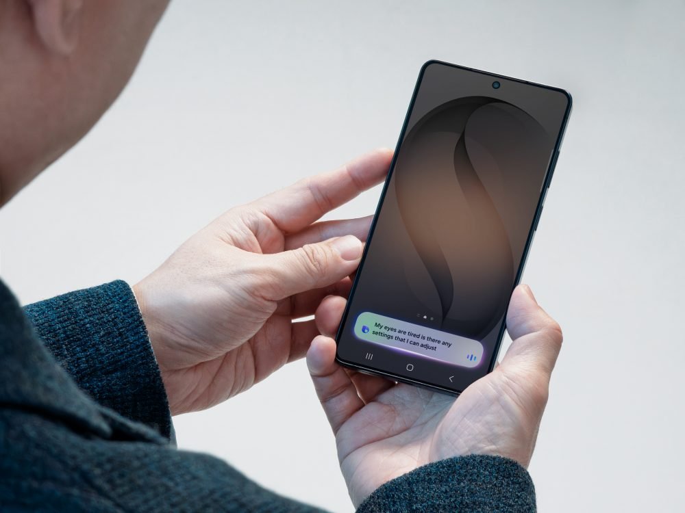 Galaxy phone showing a spoken Bixby request about tired eyes and screen settings