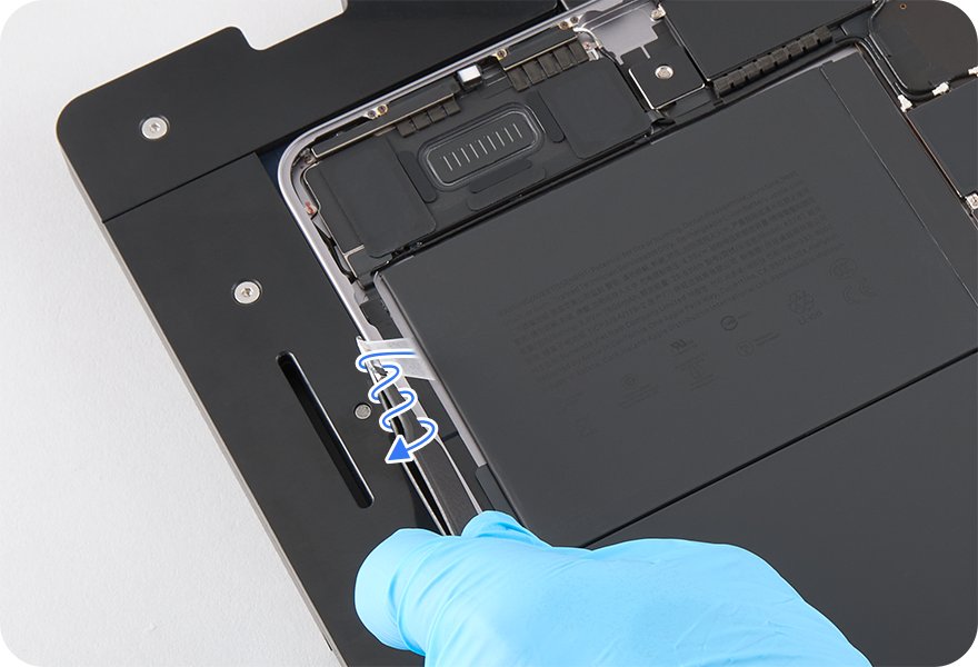 Gloved hand twisting a battery adhesive strip around ESD-safe tweezers