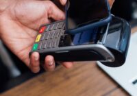 Apple Pay scam check - smartphone tapped on a payment terminal