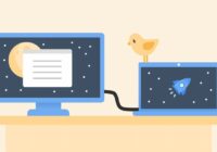 Laptop connected by cable to an external second monitor on a desk