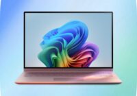 Laptop showing the Windows 11 bloom wallpaper on a blue gradient