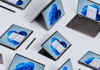 Several Windows 11 laptops and tablets arranged on a light surface