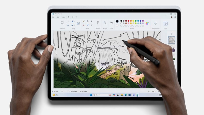 Stylus drawing on a forest sketch in Paint on a tablet