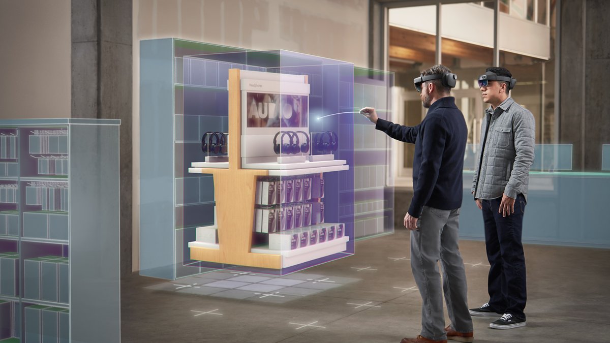 Two people wearing HoloLens 2 reviewing a holographic store display model